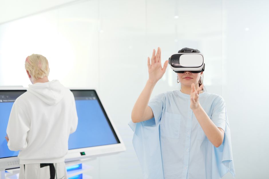 Woman exploring virtual reality with VR goggles in a modern technological environment