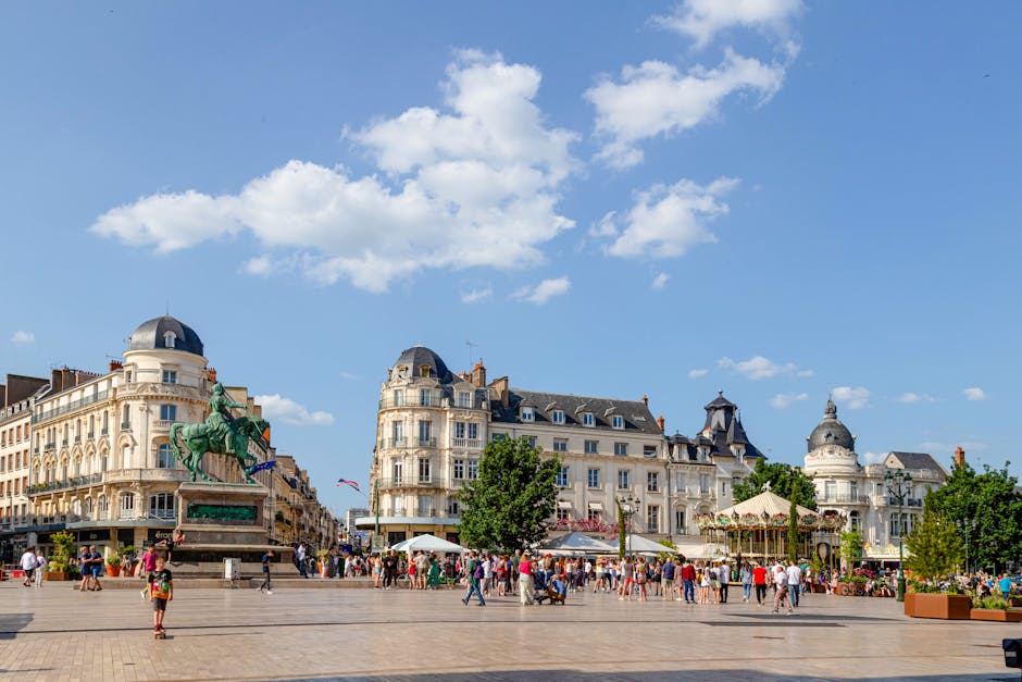 Vibrant scene in Orléans, France with historic buildings and lively crowd