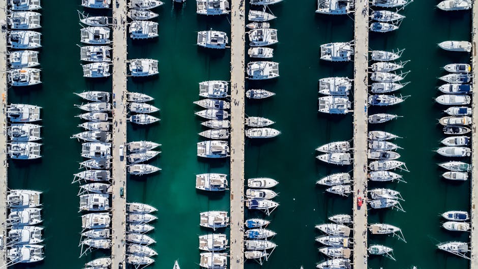 Stunning aerial shot of neatly lined motorboats and sailboats in a marina harbor
