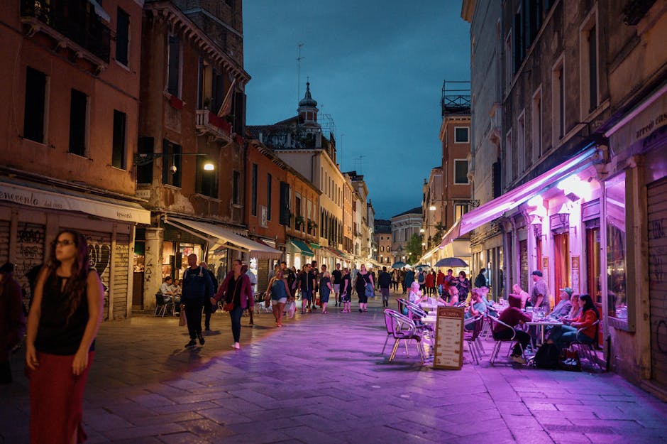 Explore the bustling nightlife of Venice with vibrant streets, historic architecture, and lively crowds.