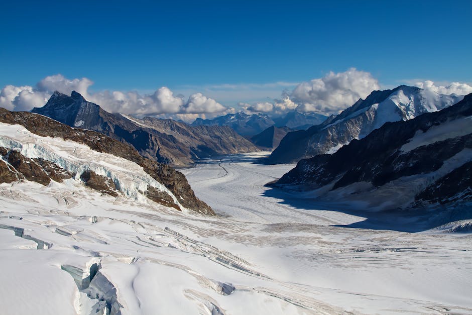 Stunning winter view of the Alpine glaciers in Lauterbrunnen, showcasing dramatic snow-covered peaks and blue skies