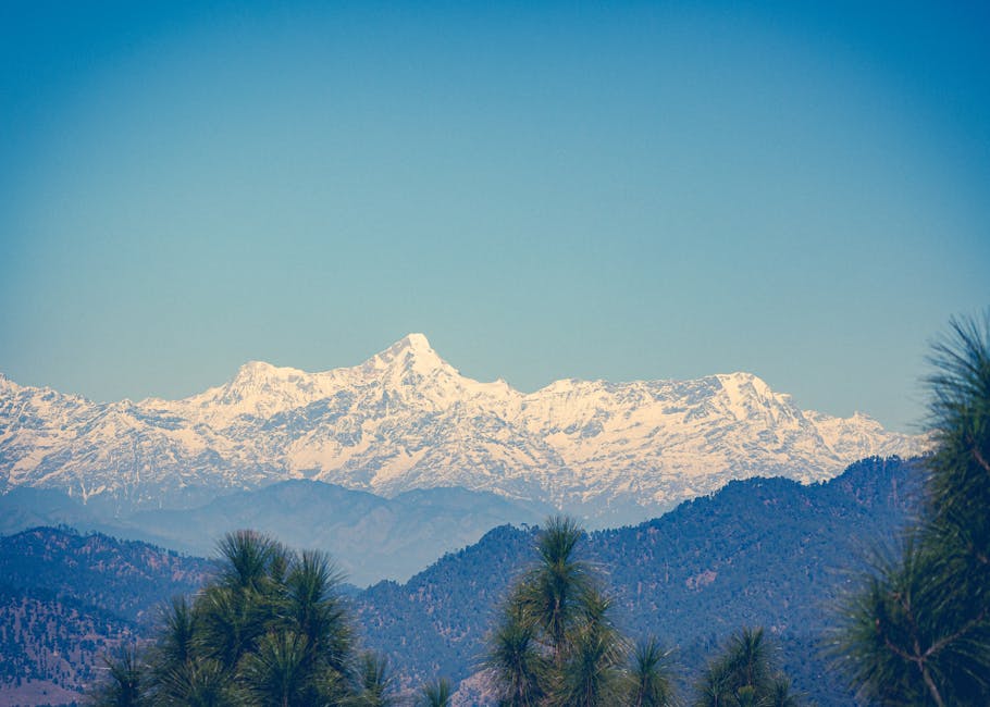 Stunning snowy Himalayas under a clear blue sky in Almora, India, showcasing breathtaking natural beauty